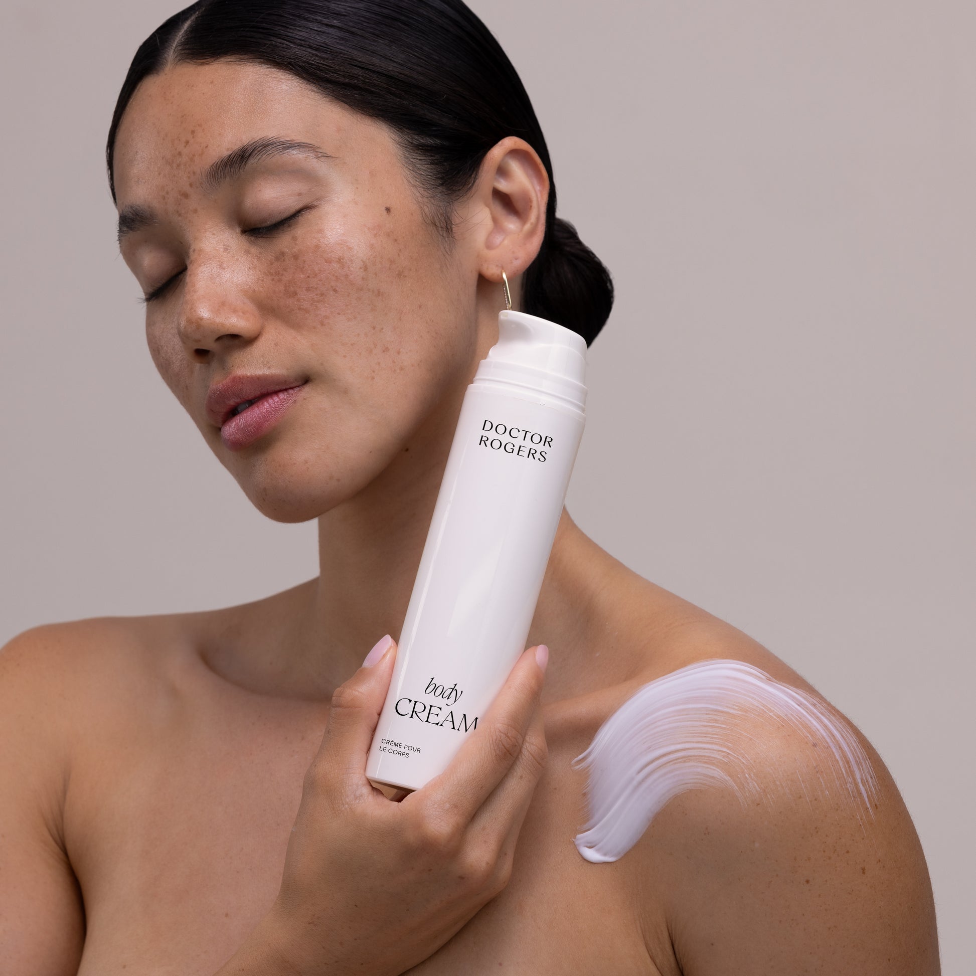 Doctor Rogers Body Duo | Featuring the Body Repair Treatment to smooth crepey skin, soften wrinkles, and even tone. Also includes Body Cream to deeply hydrate and strengthens the skin barrier using the highest-quality humectants, emollients, and ceramides.  
Picture featuring women holding white recyclable eco-friendly 6.8oz tube of Doctor Rogers Body Cream. 
Safe for men and women wtih all skin types including sensitive, mature, aging skin.