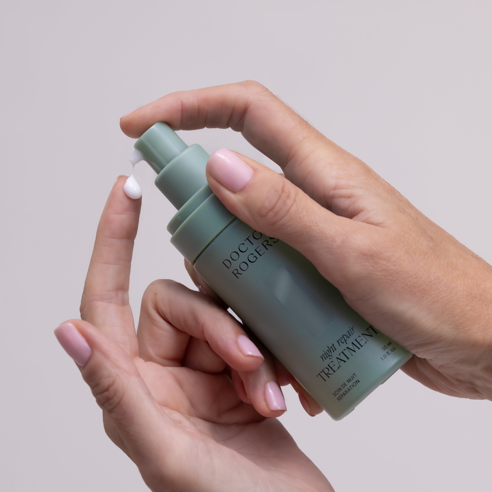 Hand pumping best retinol alternative for sensitive, mature skin Doctor Rogers Night Repair Treatment, made with bakuchiol to reduce wrinkles and fine lines, dispensing out of eco-friendly, sustainable 30 ml packaging onto index finger
