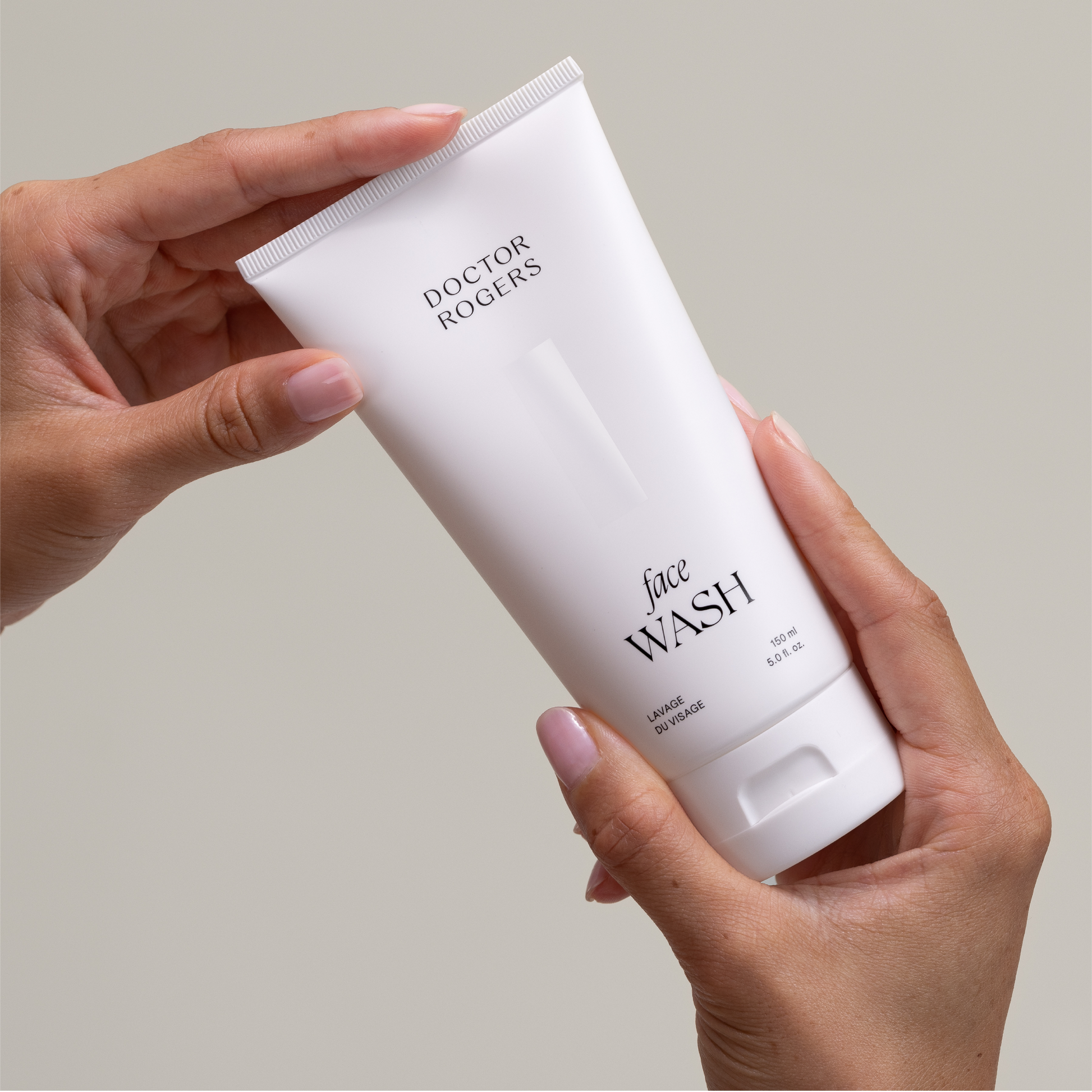 Hands holding Doctor Rogers Face Wash, the best non drying dermatologist formulated face wash to for men and women  with