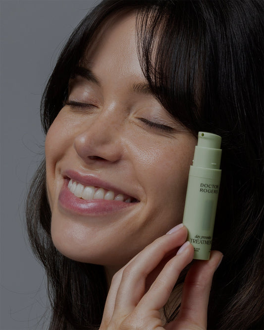 woman holding doctor rogers travel size vitamin c and antioxidant day preventive treatment 