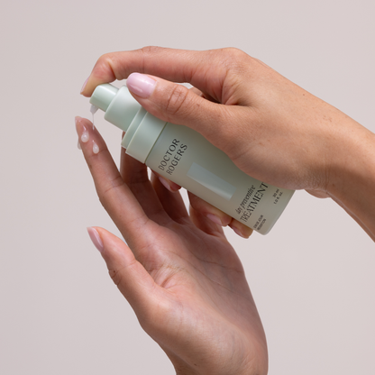 Person pumping Doctor Rogers Day Preventive Treatment, best anti-aging vitamin c serum for sensitive skin in light green sustainable, recyclable, ecofriendlypackaging onto hand to reduce wrinkles and fine lines