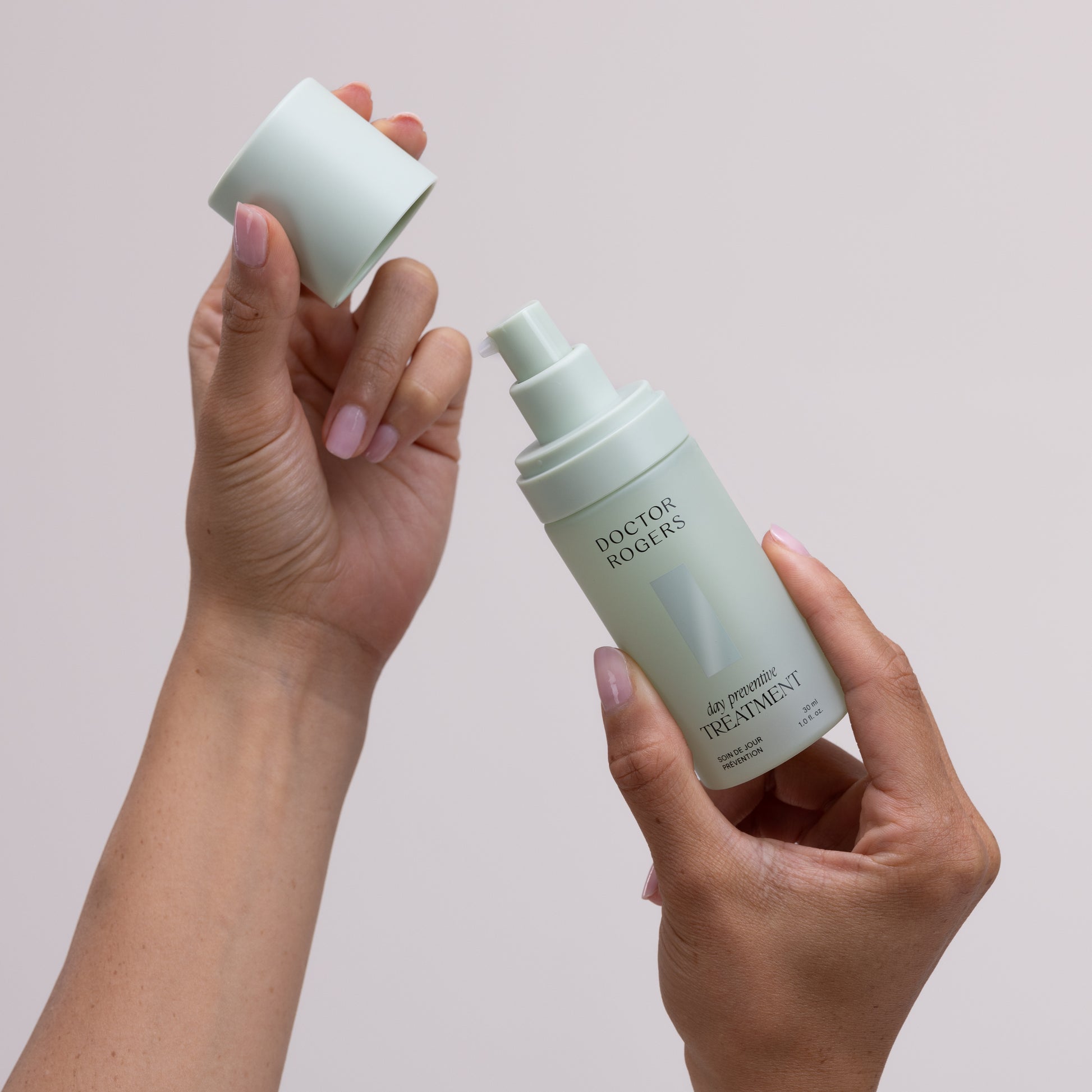 Person taking green eco-friendly lid off green recyclable bottle to dispense best anti-aging vitamin c serum Doctor Rogers Day Preventive Treatment to reduce wrinkles and fine lines on all skin including, sensitive, combination  and mature skin
