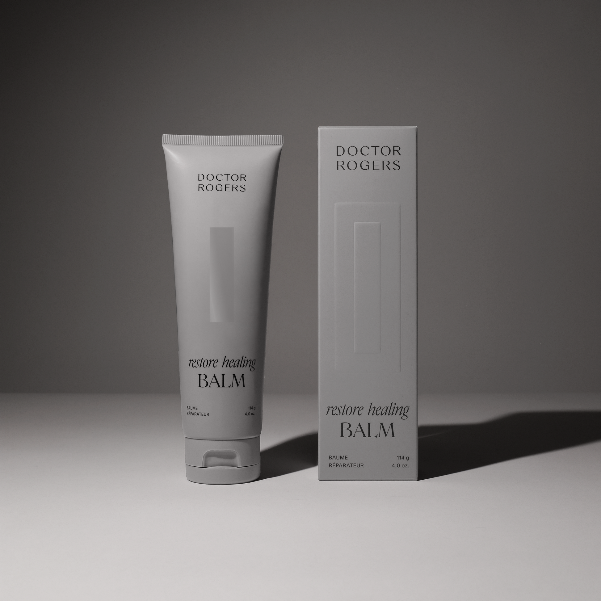 Soothing, natural Restore Healing Balm for eczema and sensitive skin relief in a 4oz tube next to its recyclable packaging.