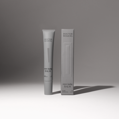 Soothing, natural Restore Healing Balm for eczema and sensitive skin relief in a 0.5 oz tube next to its recyclable packaging. 