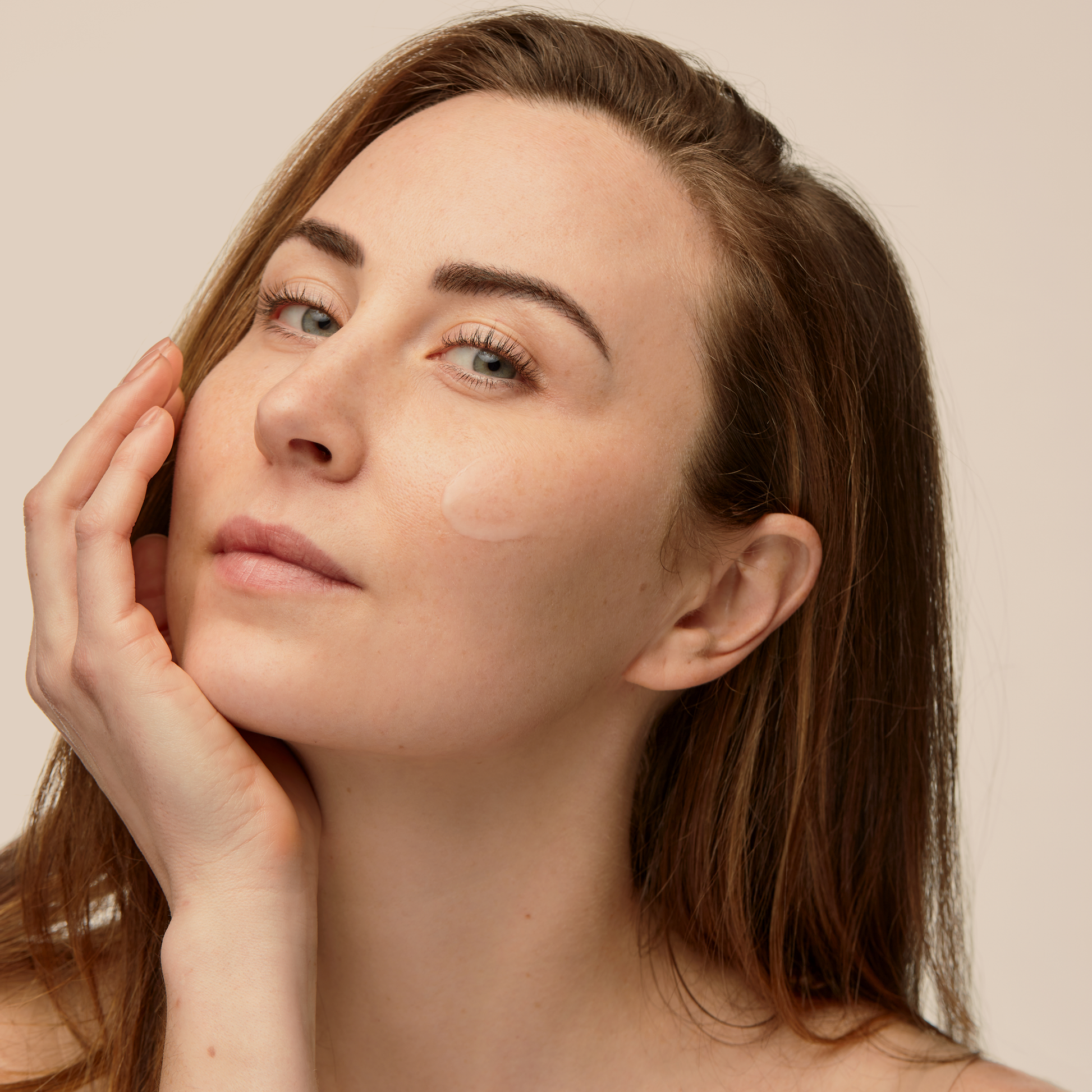 Woman wearing natural Restore Healing Balm on face for hydrating relief.