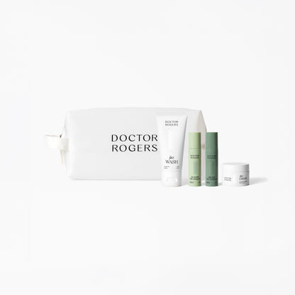 Doctor Rogers Travel Size Starter Set with mini cleanser, moisturizer, and serums in TSA-friendly bottles with toiletries bag