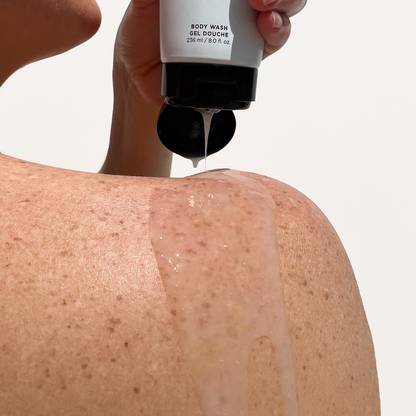 Women pouring Best Natural, unscented moisturizing Wash for men and Women on shoulder. 